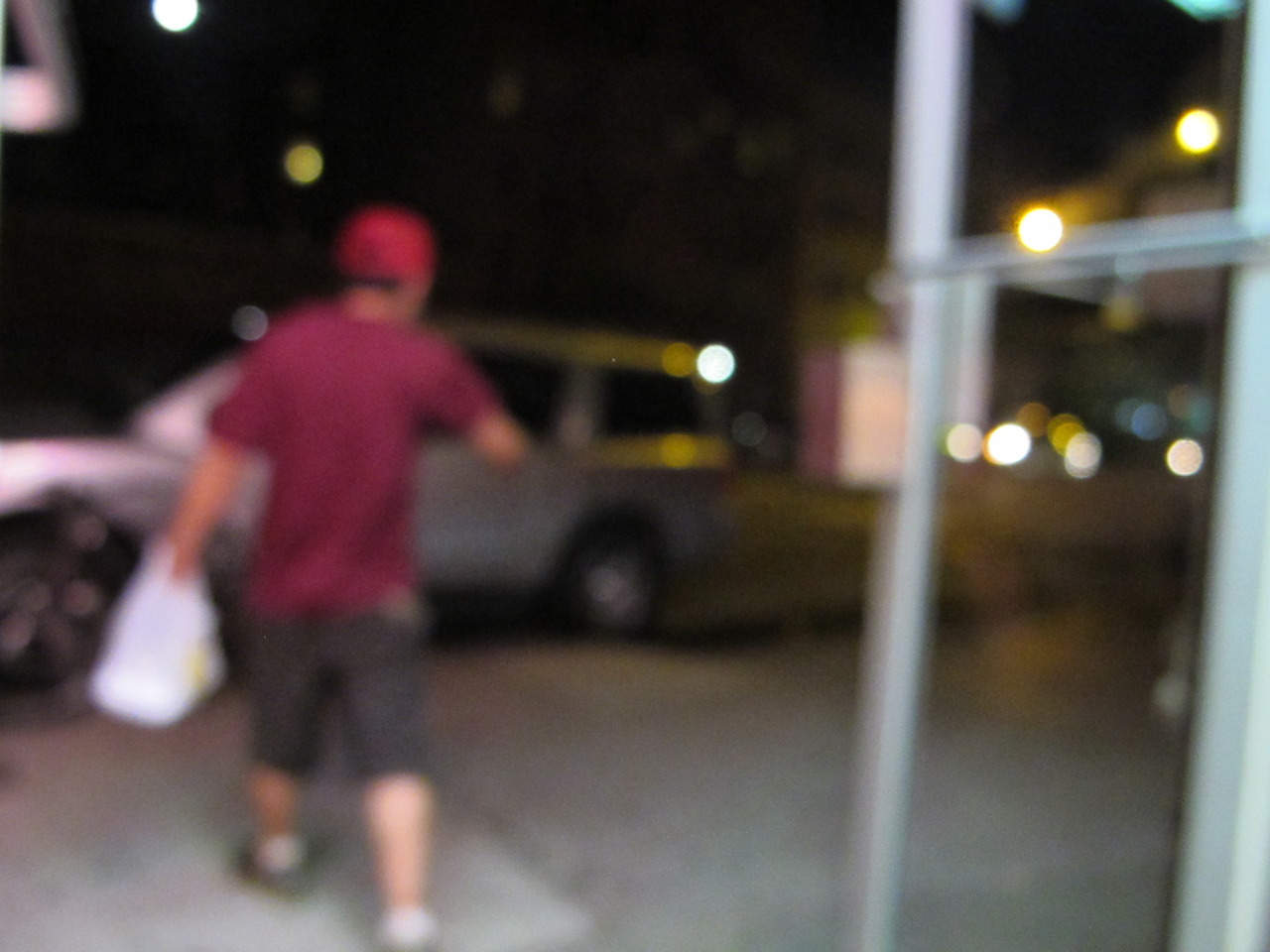 Chinese food delivery man leaving restaurant with delivery.