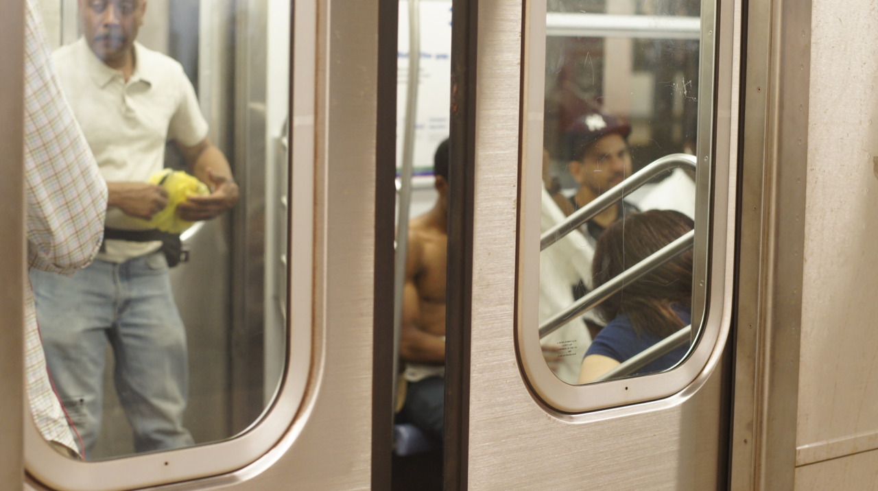 Shirtless man on subway car