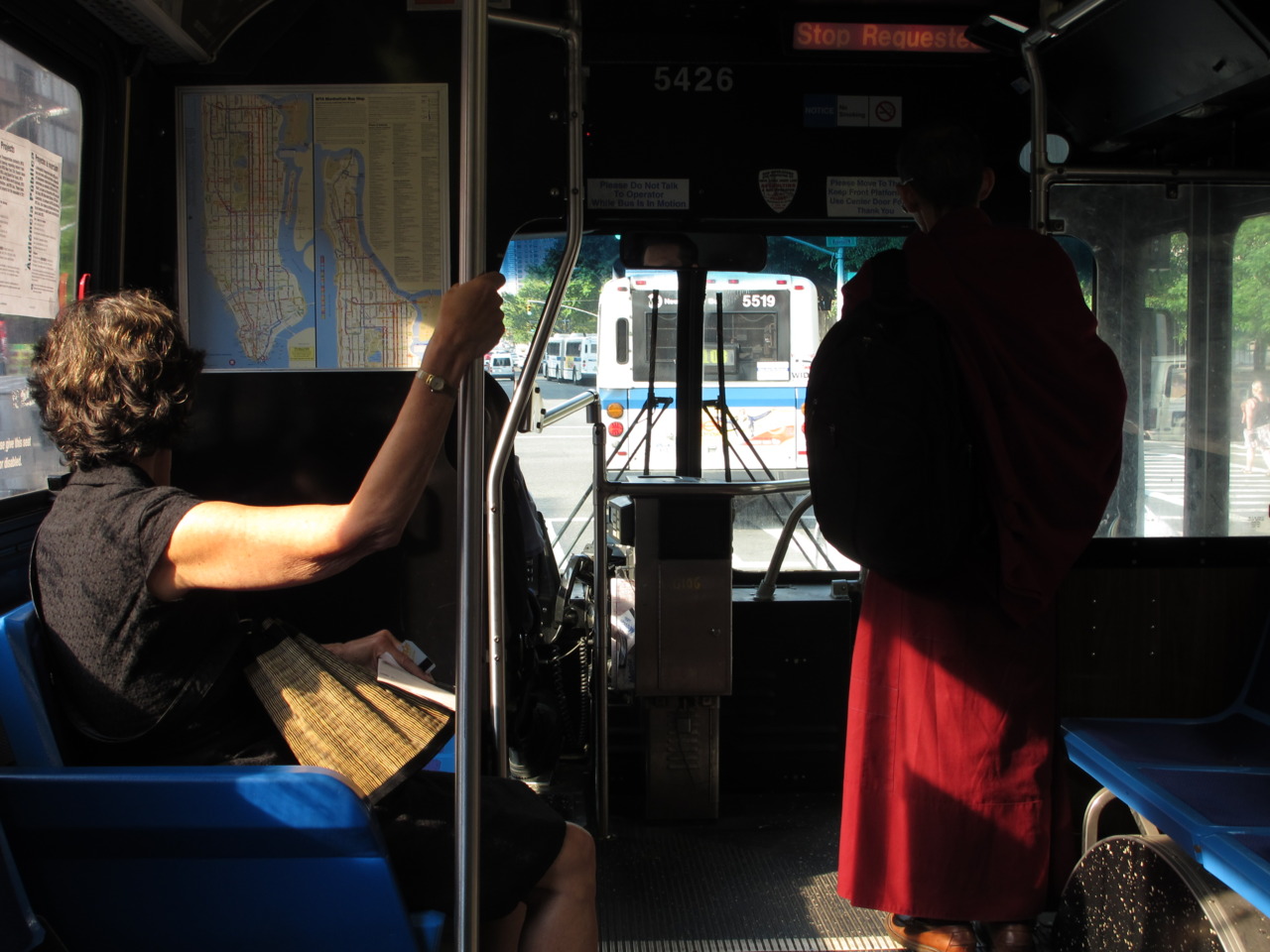 Woman and Monk on bus uptown.
