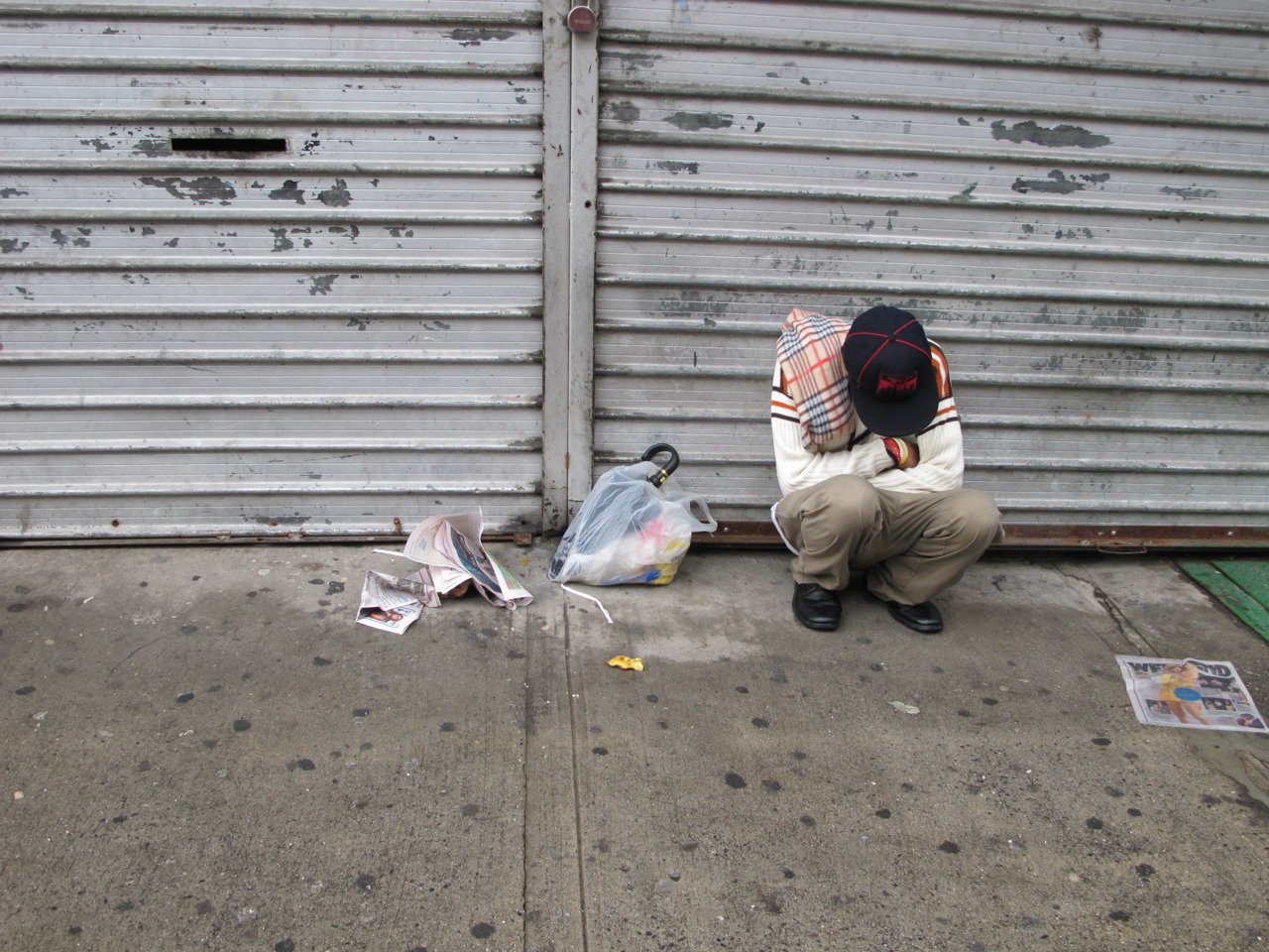 man with no home on rainy day